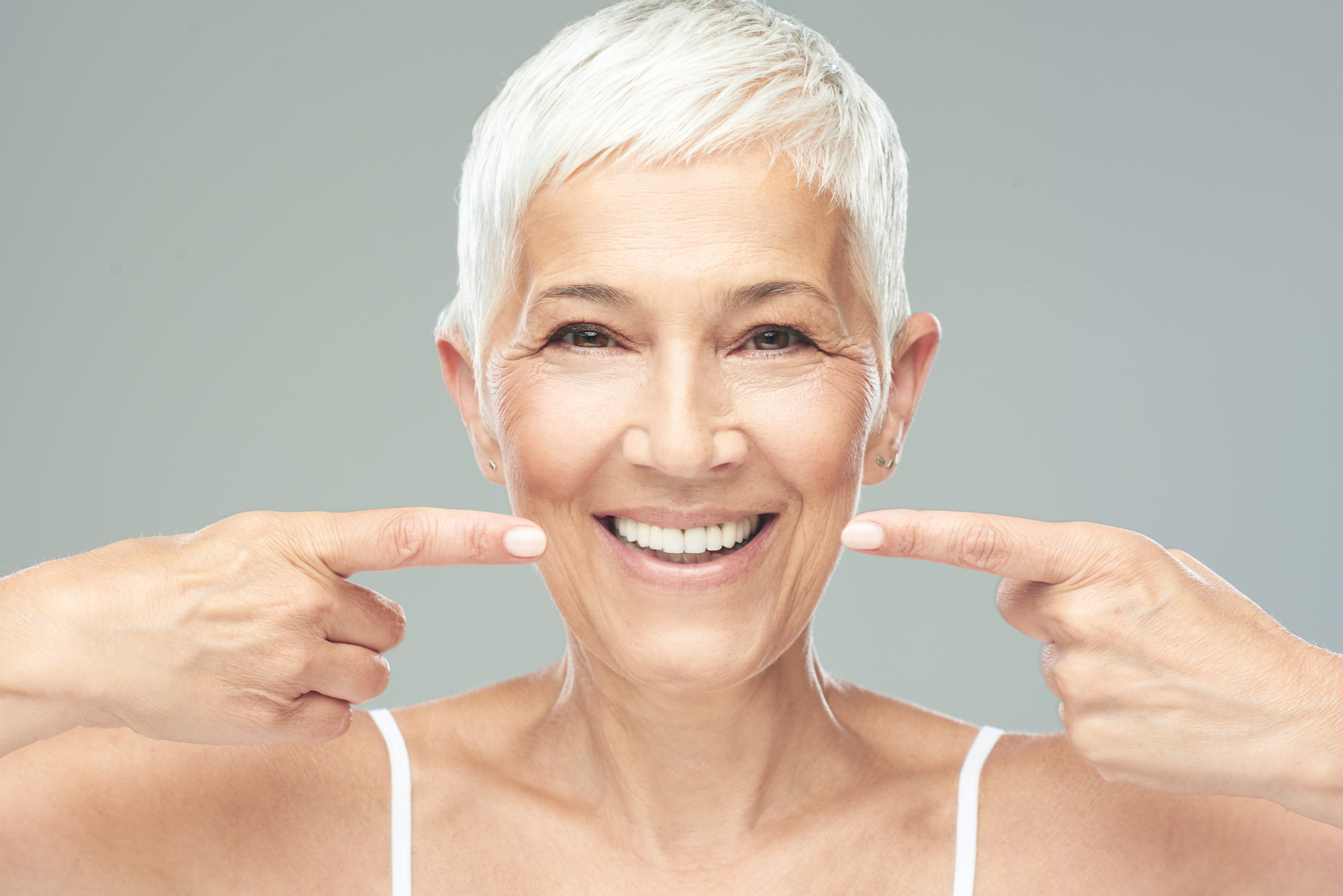 Beautiful Caucasian smiling senior woman with short grey hair p